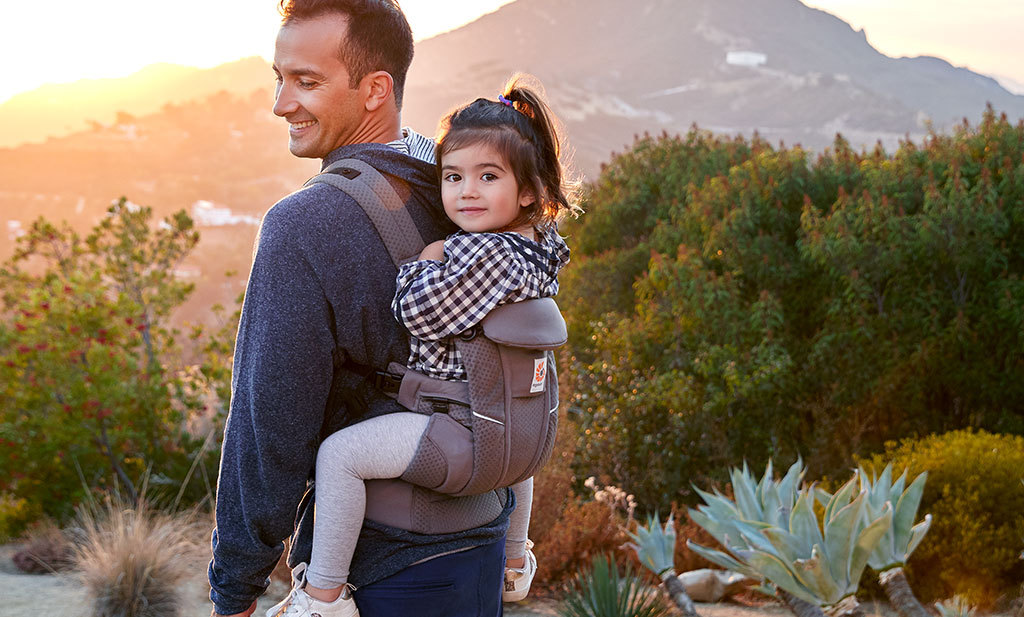 dad carrying daughter in Baby carrier