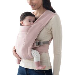 Mum wearing baby inward facing in Blush Pink Embrace Baby Carrier
