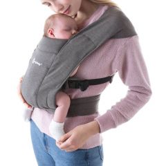 Mum wearing baby inward facing in Heather Grey Embrace Baby Carrier