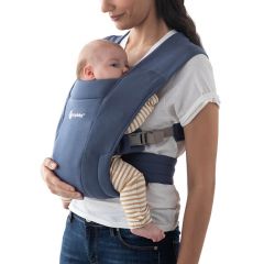 Mum wearing baby inward facing in Soft Navy Embrace Baby Carrier
