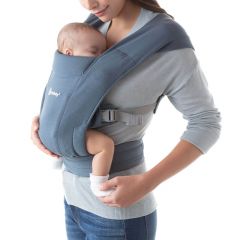 Mum wearing baby inward facing in Oxford Blue Embrace Baby Carrier