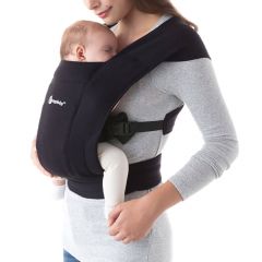 Mum wearing baby inward facing in Pure Black Embrace Baby Carrier