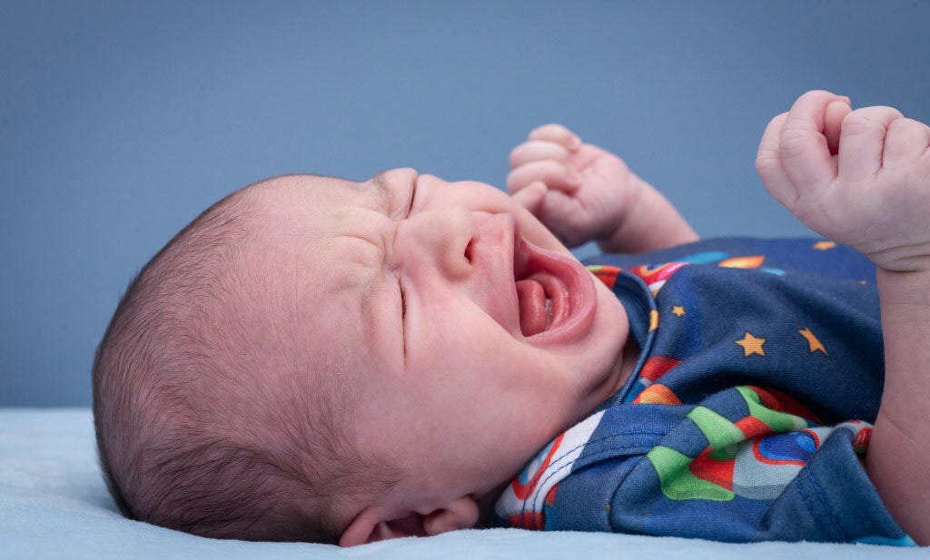 Is your newborn baby crying when you lay them down? Don’t worry it’s totally normal!