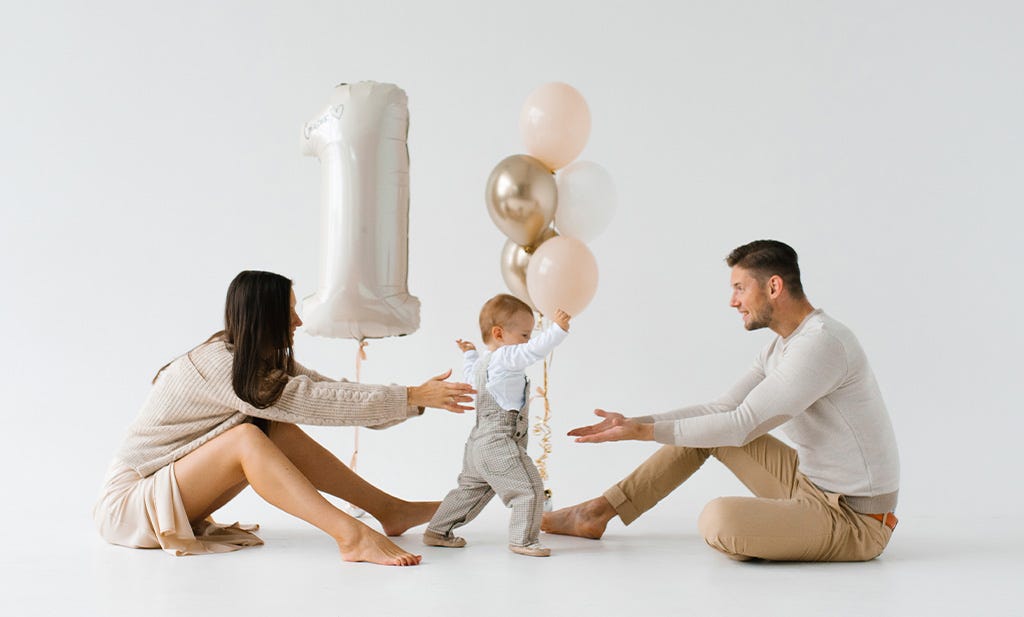 12-month baby milestones: mom and dad with a 1 year old